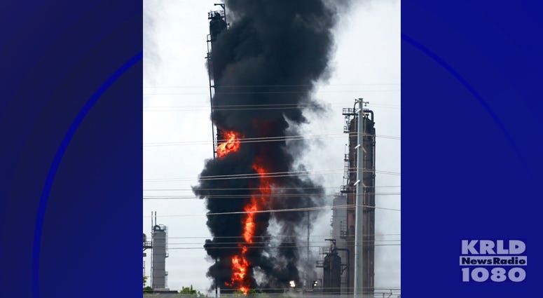 Flames and smoke rise after a fire started at an Exxon Mobil facility, Wednesday, July 31, 2019, in Baytown, Texas.