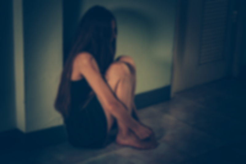 A young women seen crouching and in distress