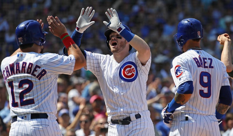 Cubs infielder/outfielder Ian Happ is greeted by teammates after hitting a grand slam against the Athletics.