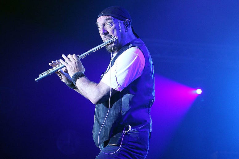 Ian Anderson of Jethro Tull plays flute on stage.