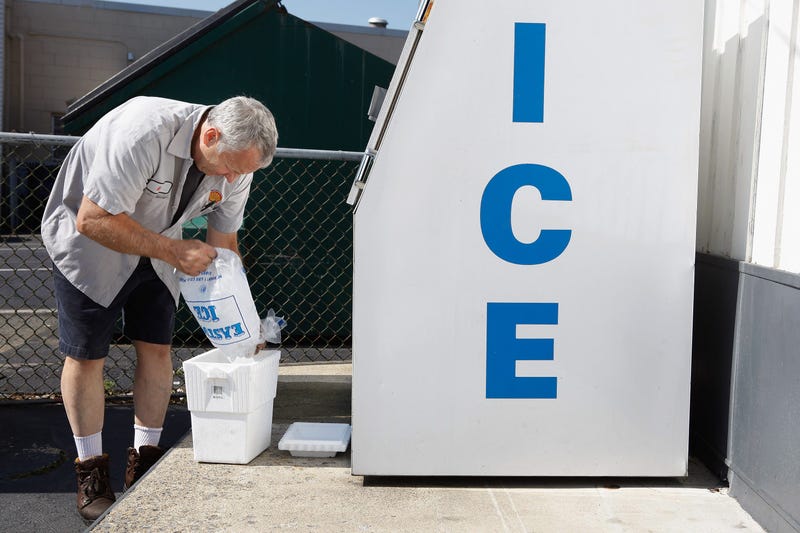 Man filling cooler with ice