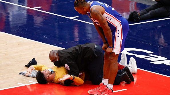 WATCH: Fan runs onto court in Wizards-Sixers game, is promptly tackled by security