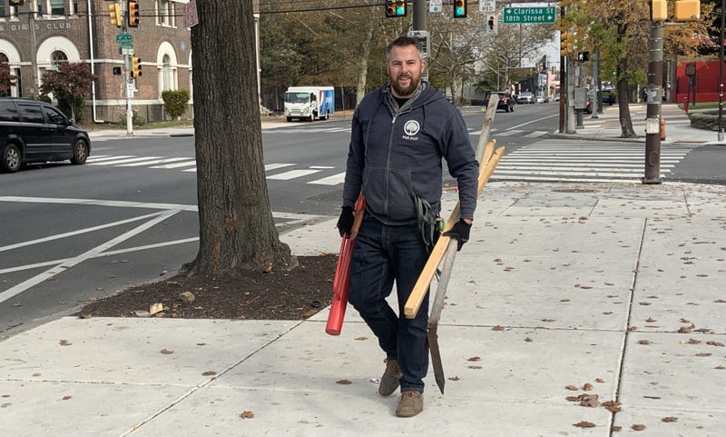 Tim Ifill, the Pennsylvania Horticultural Society's director of trees, holding tree-planting equipment