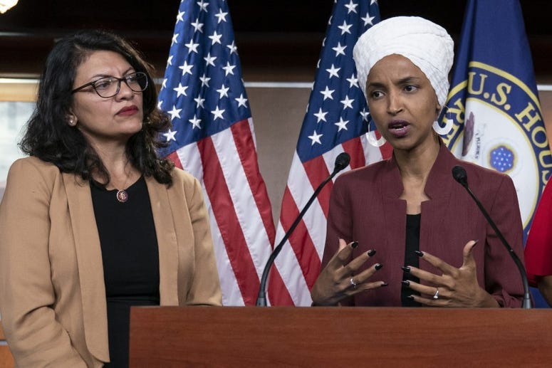 Rep Ilhan Omar speaks at a press conference with Rep Rashida Tlaib
