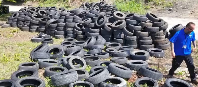 Kansas City illegal dumping investigator walks through a lot containing thousands of tires