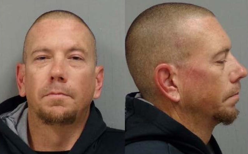 An "armed and dangerous" suspect wanted for attacking numerous people with a machete in Lenawee County was taken into police custody on Tuesday.