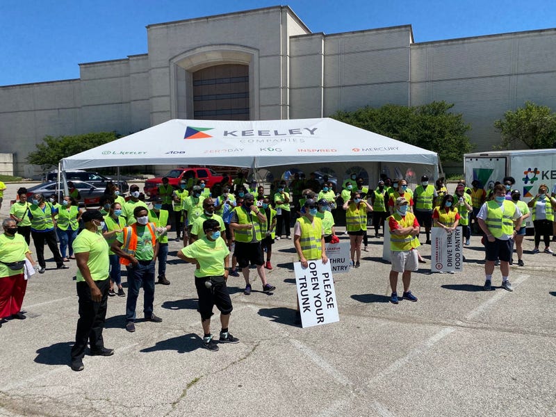 Volunteers stand ready to pass out food and supplies - June 13, 2020
