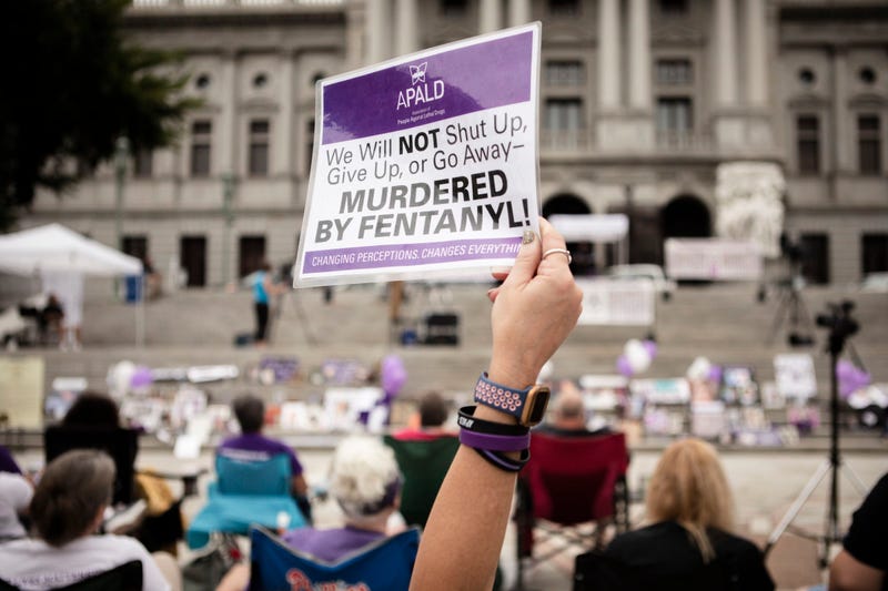 People gather on the steps of the Pennsylvania State Capitol in Harrisburg to honor lives lost to addiction during 2021's Overdose Awareness and Memorial Day.