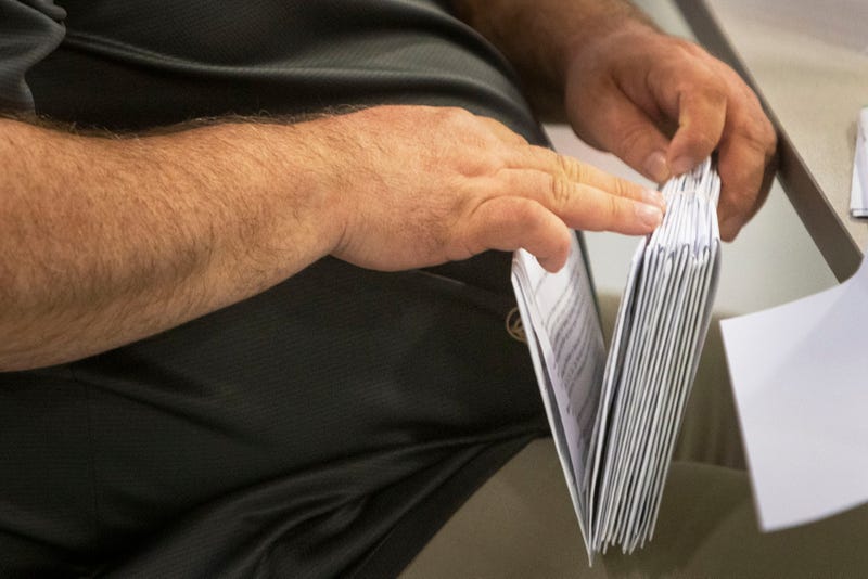 man counting mail ballots