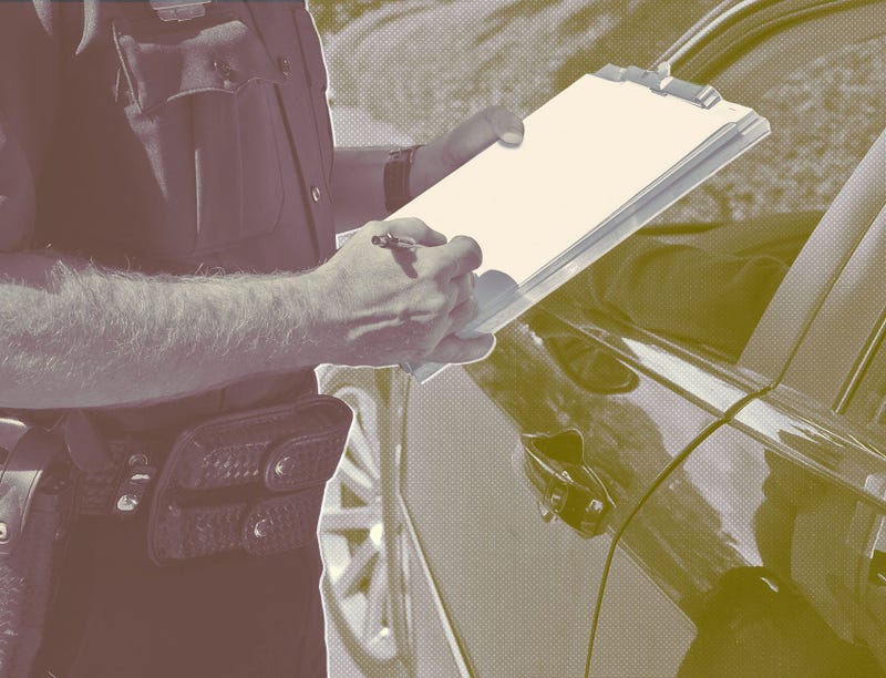 police officer giving driver a violation