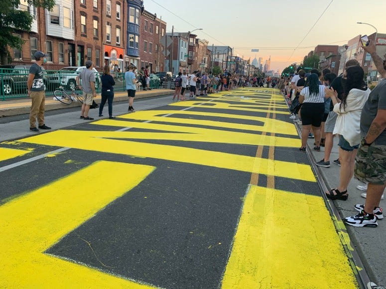 People painting "End Racism Now" in Fishtown 