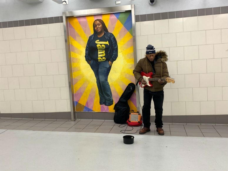 Musician Raymond de la Cruz performing at SEPTA concourse. 