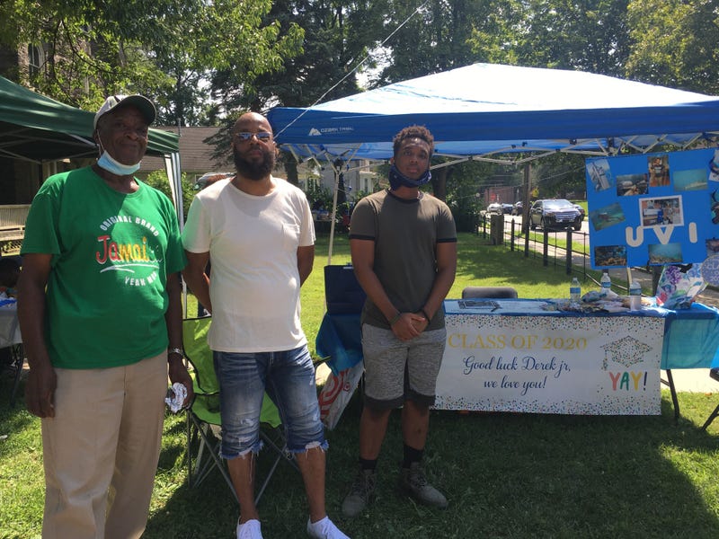 Three generations of the Koons family, among other friends and neighbors, came together to celebrate Derek Koons Jr. (right) and other graduates with a trunk party at New Hope Baptist Church in Germantown.