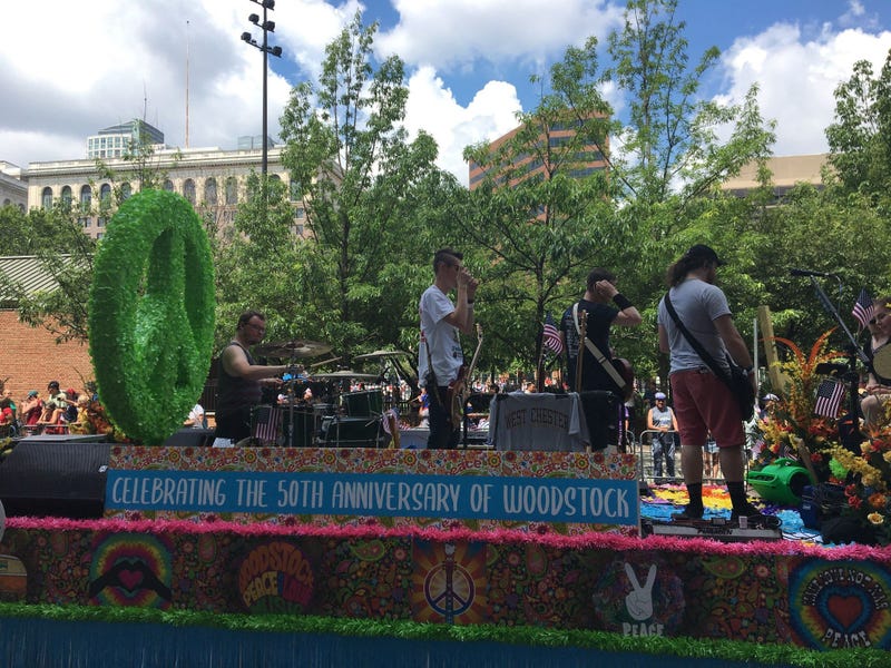 A float celebrating the 50th anniversary of Woodstock is in the 2019 Independence Day Parade.