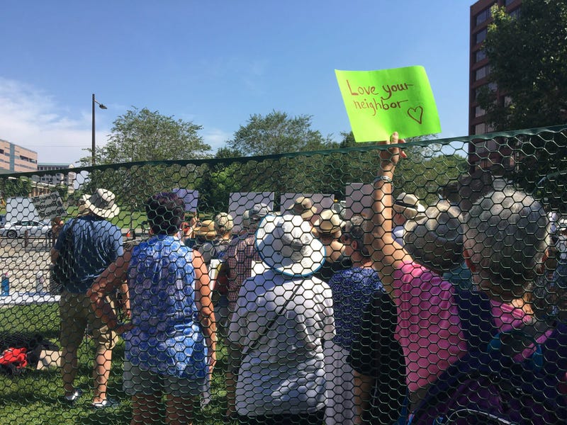 Dozens of seniors packed themselves into a small, makeshift enclosure today, and stood outside in the dangerous heat and humidity to protest migrant family separation and child detention. 