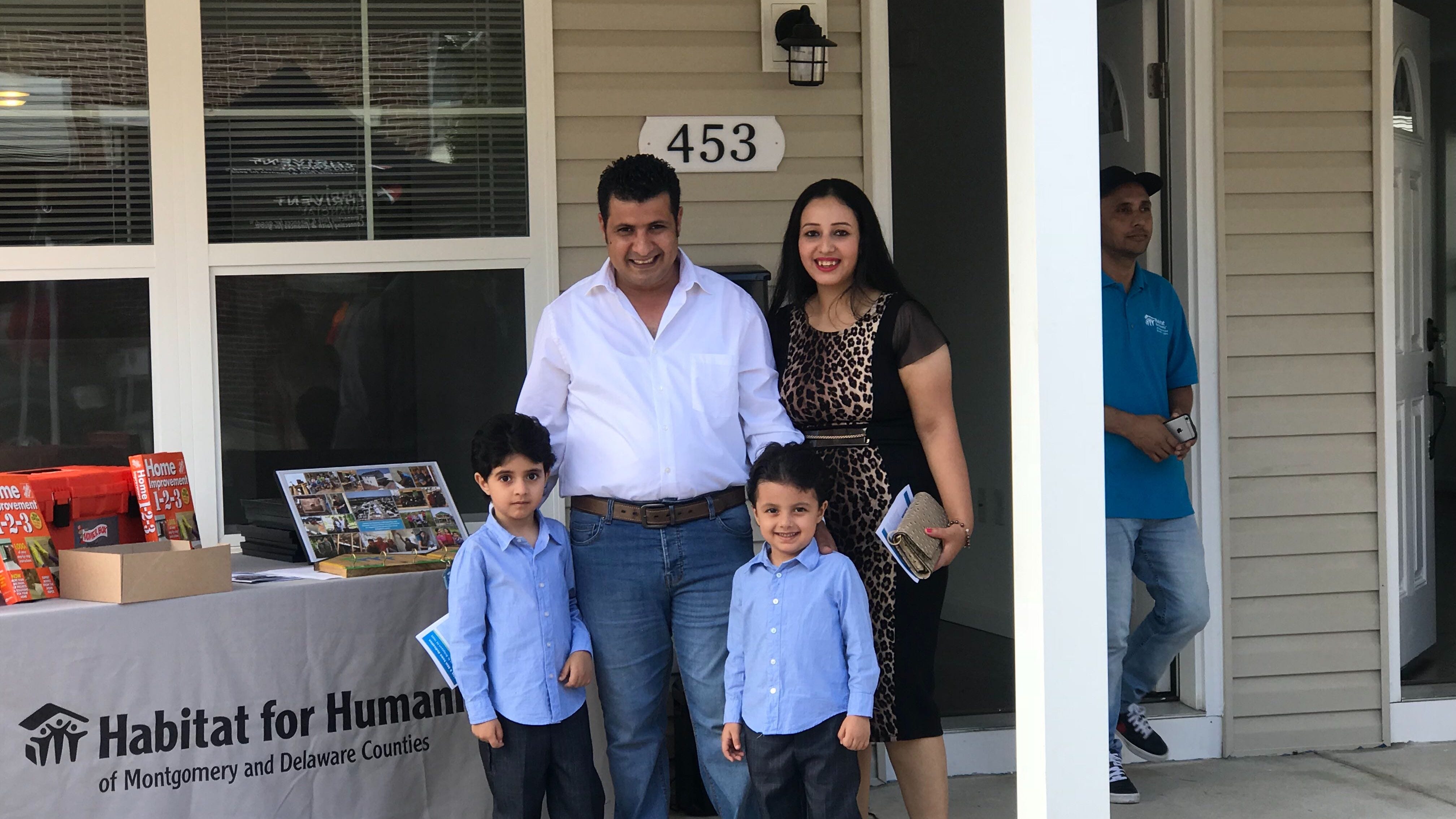 Habitat for Humanity helps 2 immigrant families build, buy their homes