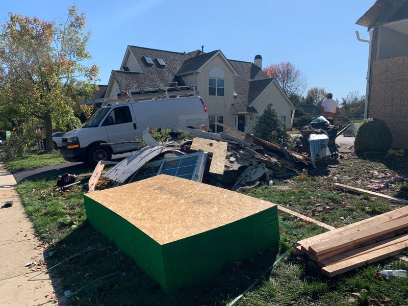 Building materials piled next to debris left after an EF2 tornado struck a Glen Mills development on Halloween night.