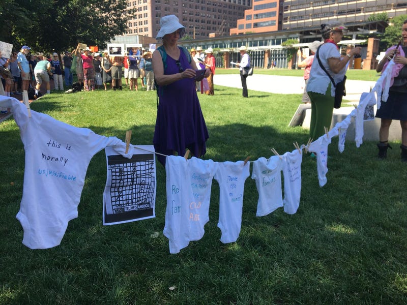 Dozens of seniors packed themselves into a small, makeshift enclosure today, and stood outside in the dangerous heat and humidity to protest migrant family separation and child detention. 