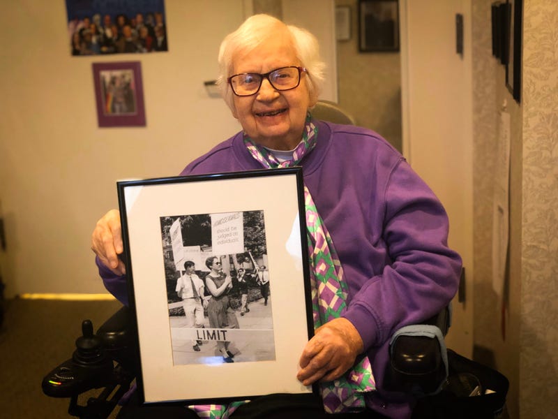 Kay Tobin-Lahusen holds a photograph she took of her partner and fellow activist Barbara Gittings.