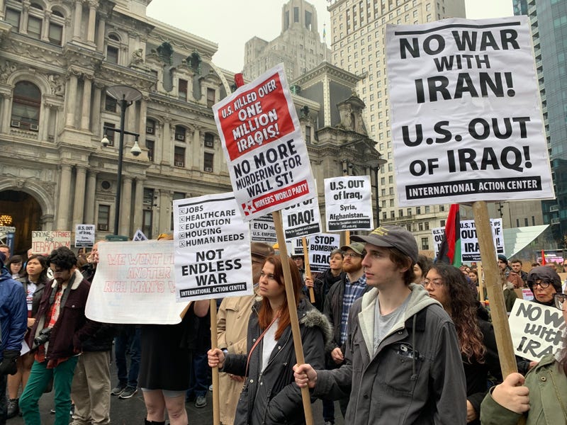 Protesters gathered at City Hall to oppose a potential war in Iran.
