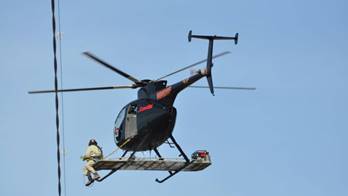 ComEd will be installing bird diverters on its power lines to help make them more visible to birds and prevent collisions with power lines. As shown below, a transmission overhead lineman will be aboard a helicopter, equipped with a platform and strapped on with a safety harness, to manually install the bird diverters to the line.