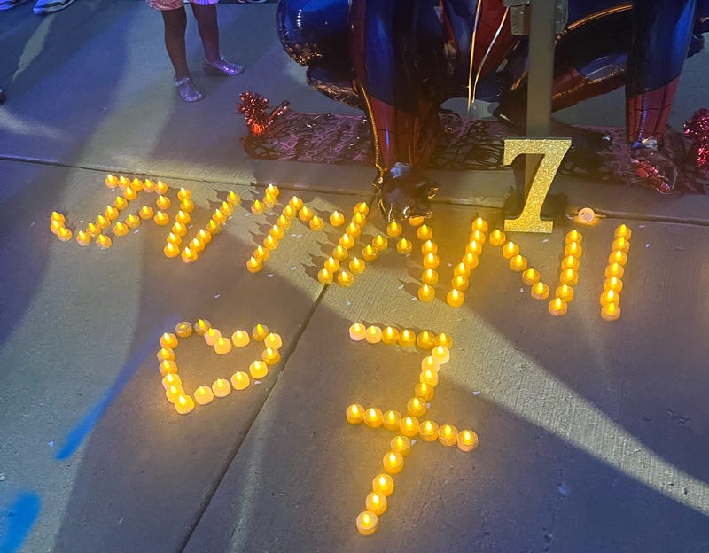 Candles are laid out on the ground in honor of Jai'Mani Amir Rivera, a 7-year-old boy who was shot and killed last week on Chicago's Near West Side.