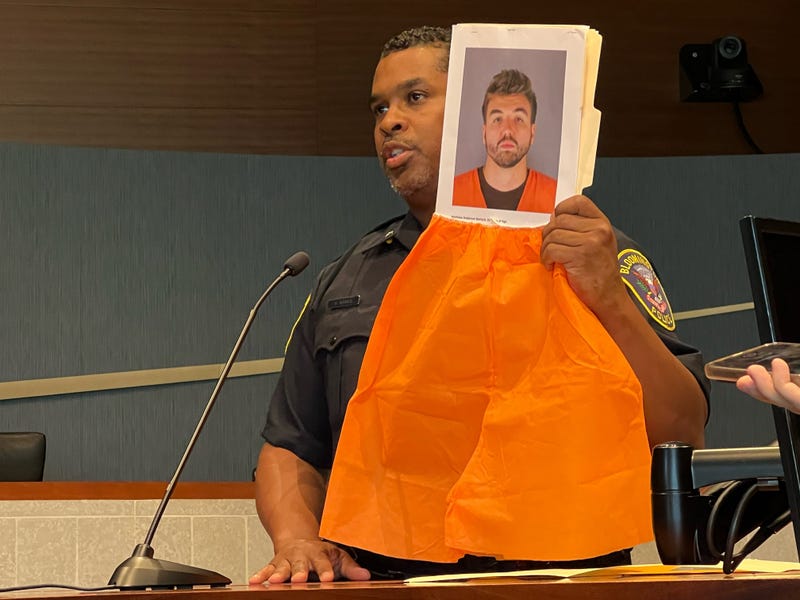 Bloomington Police Chief Booker Hodges holds up pictures of 28-year-old Matthew Anderson Bertsch, an 8th grade teacher in Richfield who was charged with Criminal Sexual Conduct 2nd Degree, among other charges.