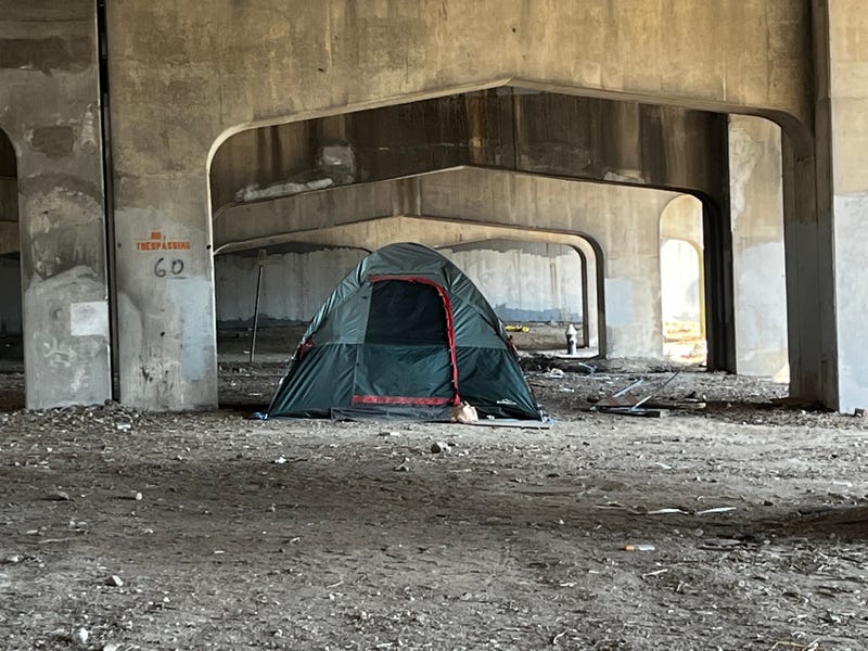 tent set up under highway overpass
