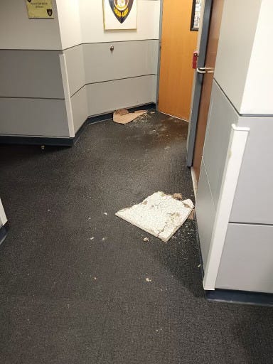 Water damaged tiles lay on the damp floor of the St. Louis County Jail