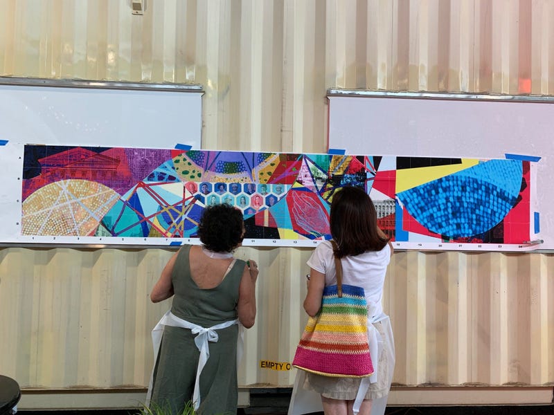 Members of the public were invited to help paint sections of a mural at Cherry Street Pier.