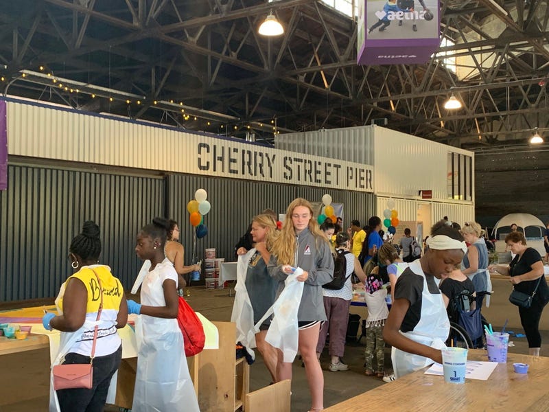 Members of the public were invited to help paint sections of a mural at Cherry Street Pier.