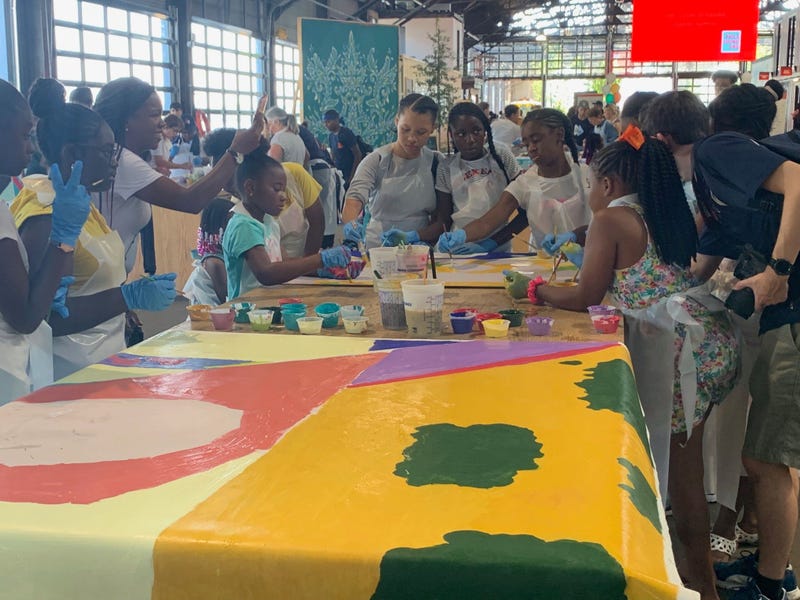 Members of the public were invited to help paint sections of a mural at Cherry Street Pier.