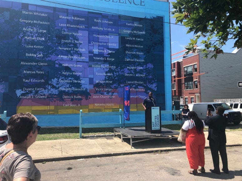 The anti-violence mural that struck community controversy a year ago when a developer mistakenly destroyed it has been officially restored and was dedicated Wednesday.