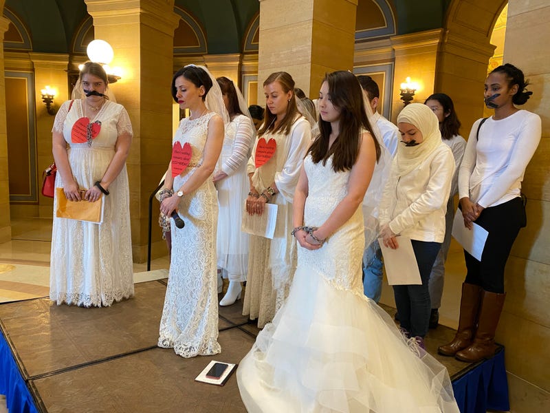 Signs read "There's nothing romantic about child marriage"