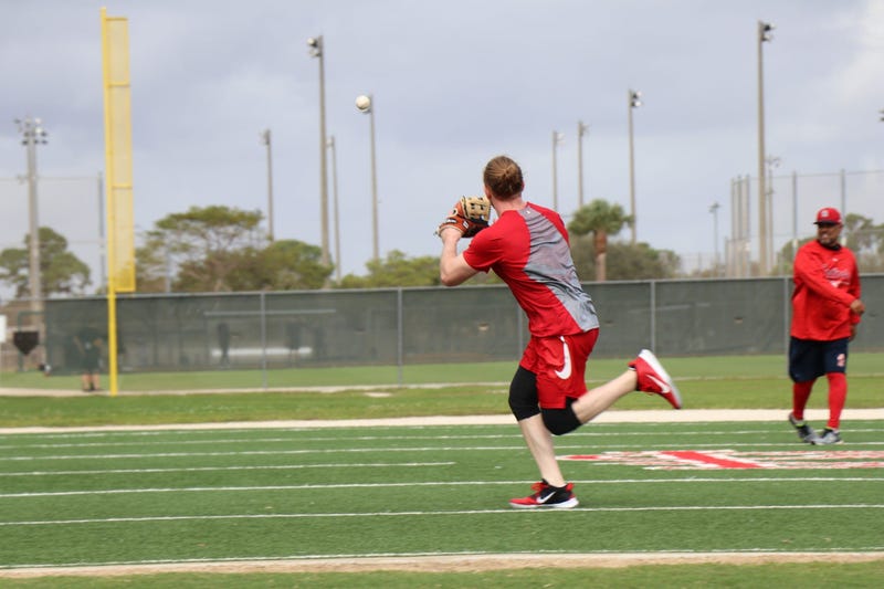 Outfielder Harrison Bader works with coach Jose Oquendo on an outfielders drill.