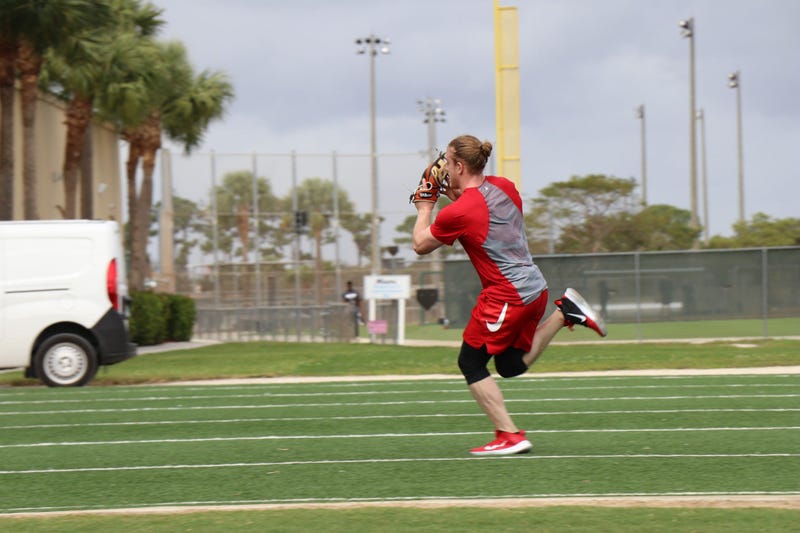 Outfielder Harrison Bader works with coach Jose Oquendo on an outfielders drill.