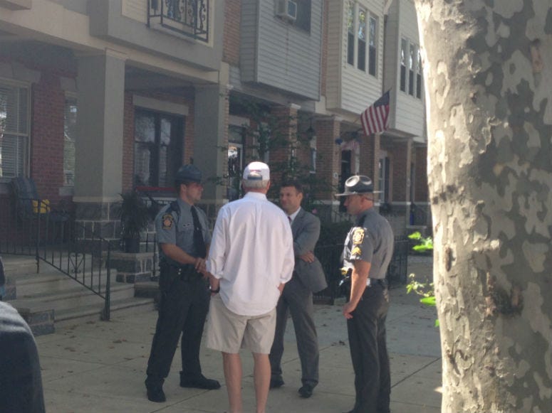 In this photo, John Dougherty is seen talking to agents when federal authorities raided his house in August 2016. 