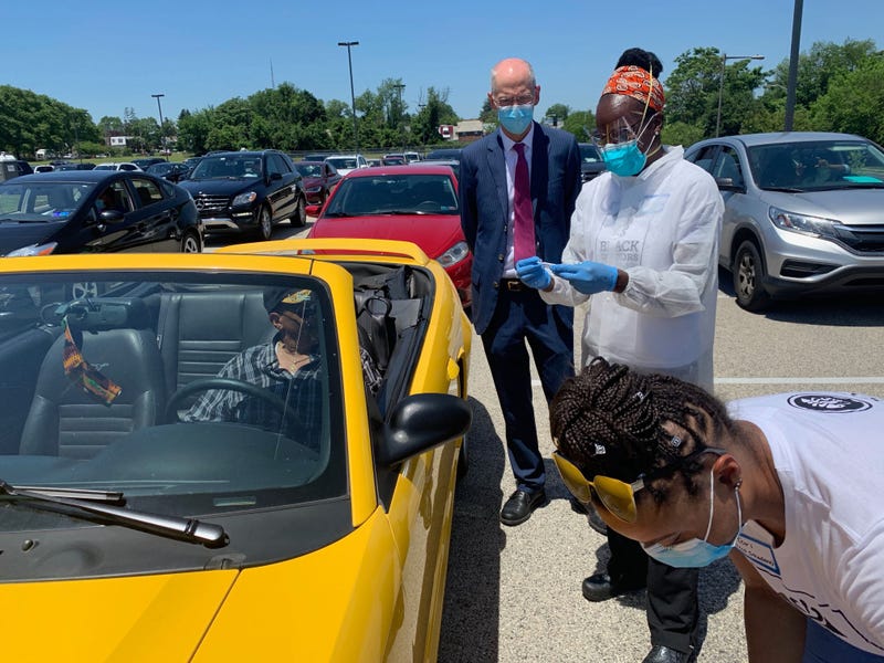 Philadelphia Health Commissioner Dr. Thomas Farley watches as Dr. Ala Stanford and an aide conduct COVID-19 testing at Enon Tabernacle Church.