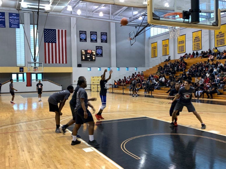 Philly cops and a group of young men play a friendly game of basketball at Community College of Philadelphia.