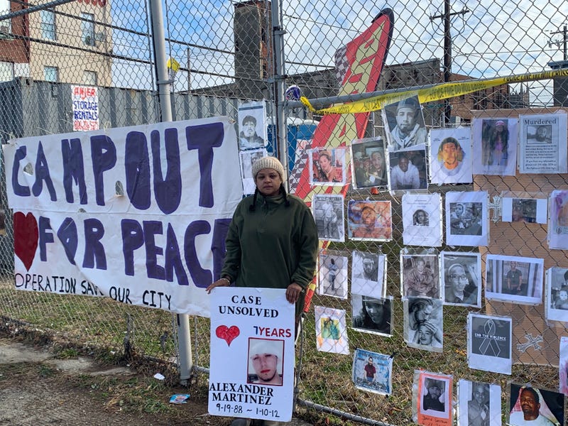 Operation Save Our City founder Rosalind Pichardo poses with a photograph or her brother, whose 2012 murder remains unsolved.