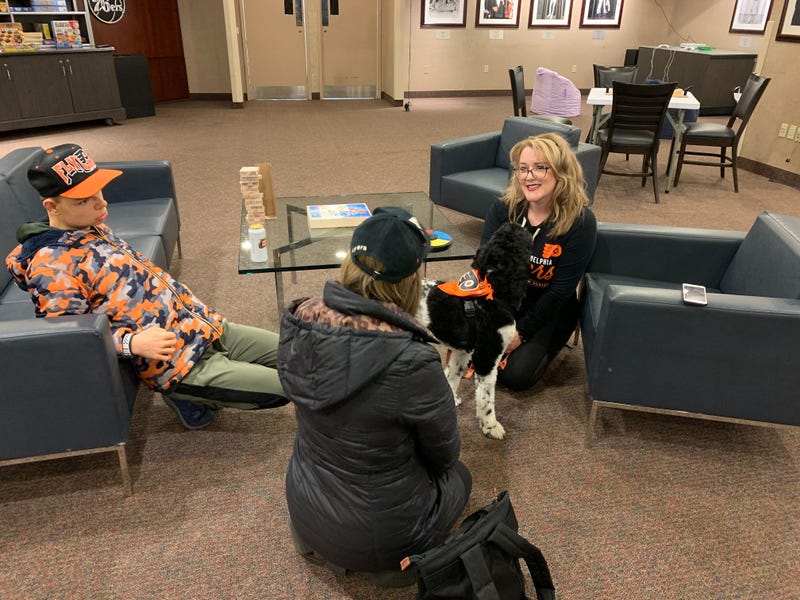 17-year-old Jack Stockmal (left) and his mother Carrie (middle), with neuropsychologist Jennifer West-Gavin and service companion dog Lullaby (right).