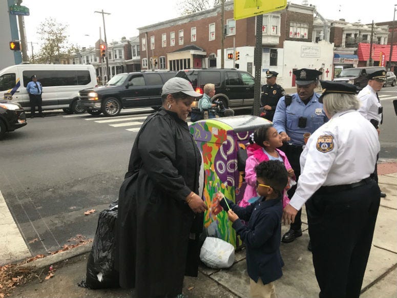 Philadelphia police hand out candy in Cedar Park.