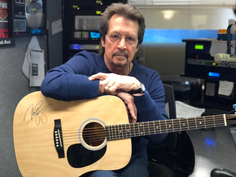 Michael Stanley with a signed acoustic guitar