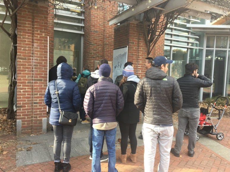 Tourists try to get a glimpse and a photo of the Liberty Bell through the glass of the closed site. 