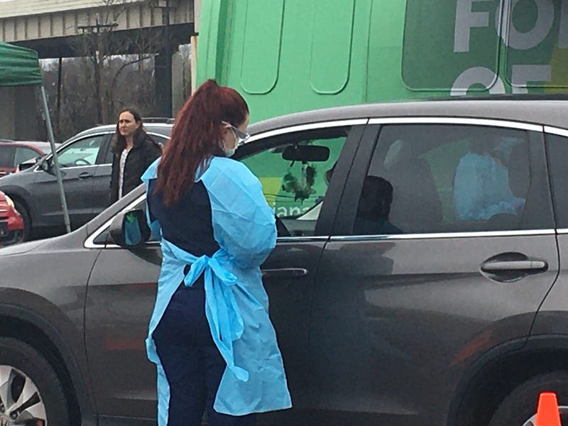A nurse consults with a person seeking a coronavirus test.