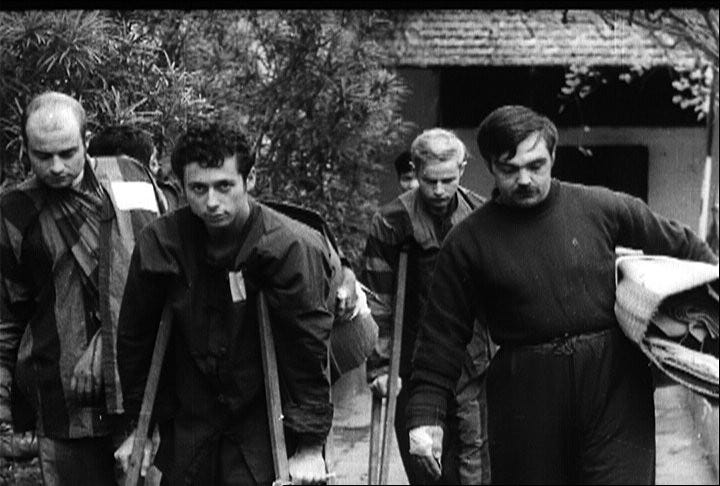 Bill Arcuri on crutches, front middle taken while a POW