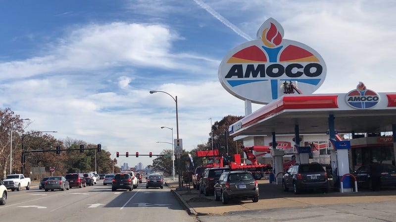 Workers repaint the landmark Amoco sign near Forest Park