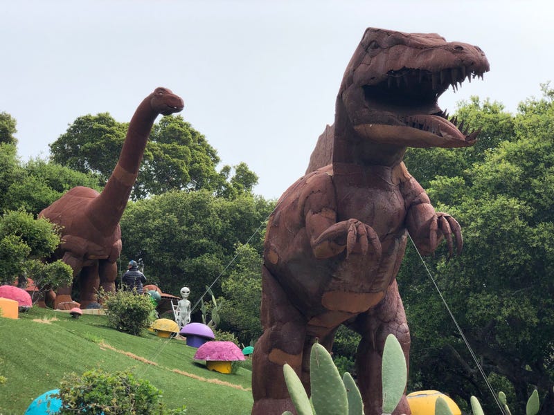 Statues of dinosaurs are among the many decorations in the yard of the Flintstone house of Hillsborough.