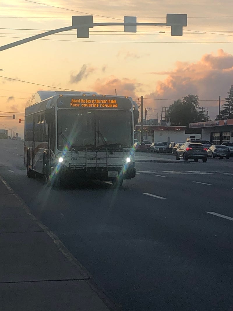 A SamTrans bus flashes a warning about rear boarding during the coronavirus pandemic.