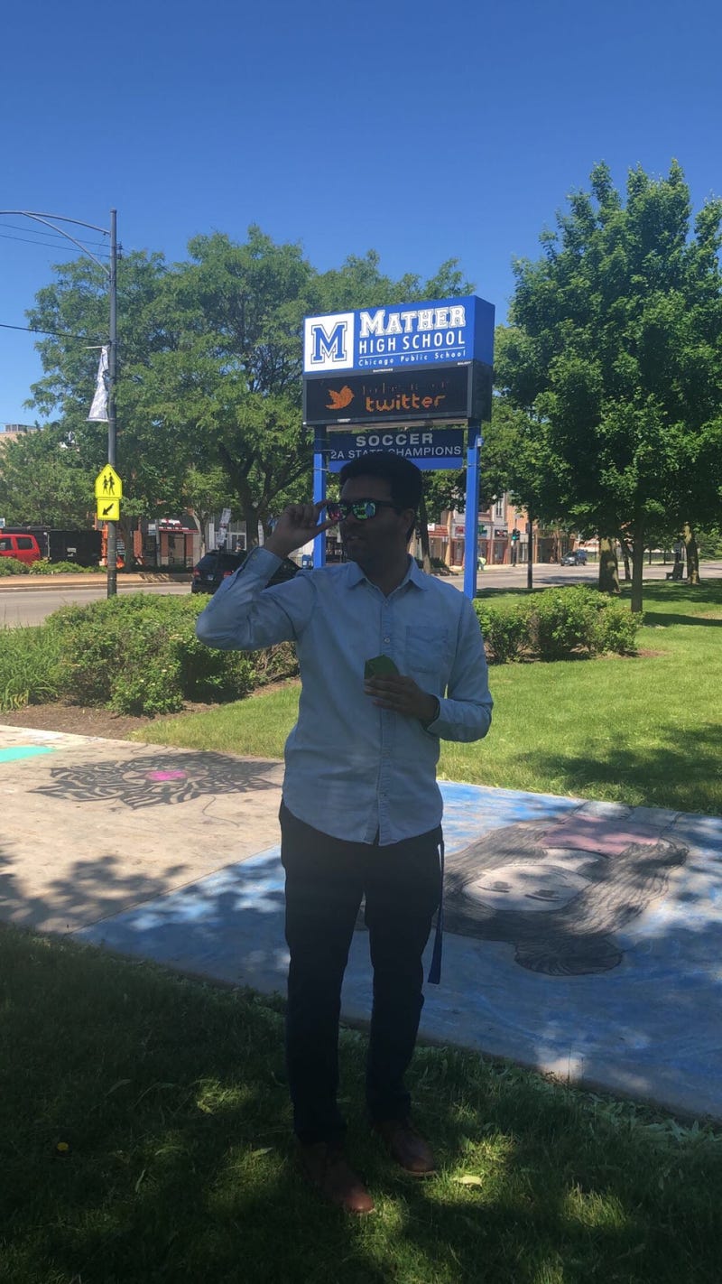 Mather High School Senior English Teacher Aneesh Shukla receives Enchroma glasses from his students